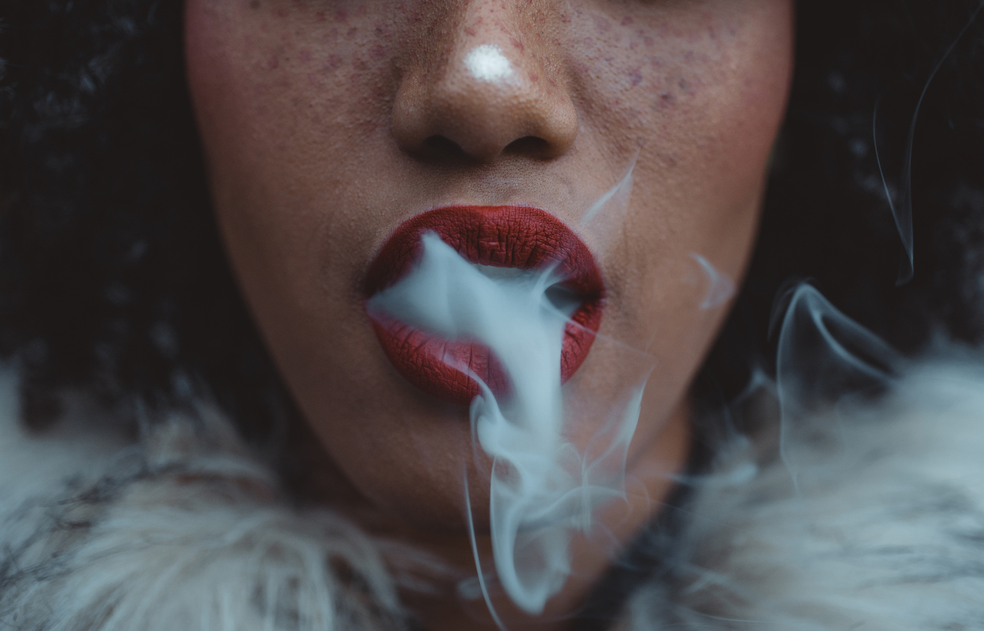 Close Up Shot of a Woman Blowing Smoke